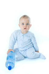 Fototapeta premium baby boy and bottle of mineral water, on white