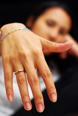 Woman holding up engagement ring