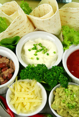 Mexican vegetarian platter with tortillas and sour cream