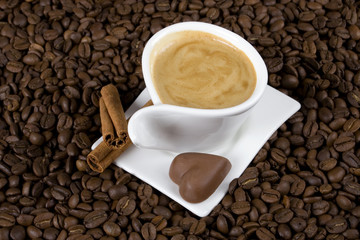 Cuo of espresso coffe with heart shaped chocolate candy