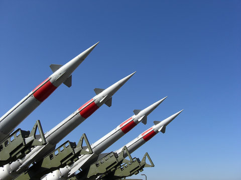 Four missiles against clear blue sky