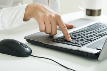Image of forefinger pressing key of enter