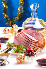 Holiday table setting with delicious whole baked sliced ham