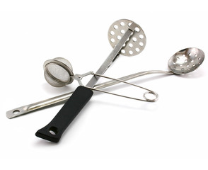 Two perforated spoons and tea strainer isolated