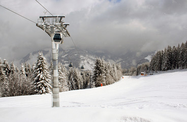 Alpine skilift in snowy Swiss alps mountains scene
