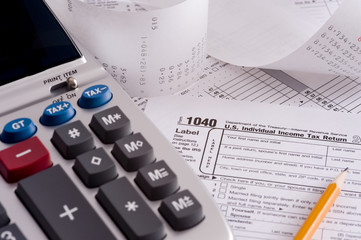 An adding machine or calculator with tax forms