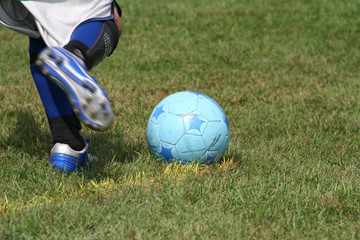 A soccer goalie attempting a kick from the corner of the box