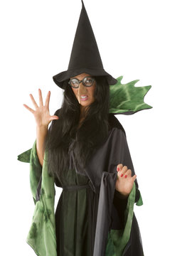 old and ugly witch in black and green dress with glasses