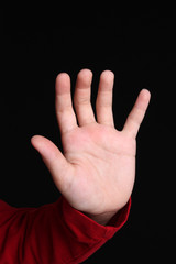 Hand of a young girl on black background