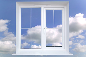 Window frame against a blue cloudy sky