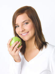 Portrait of beautiful young woman holding green apple