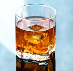 Whiskey in glass with ice cubes
