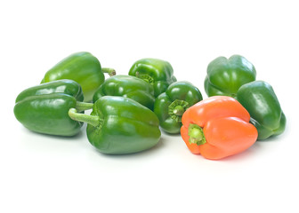 Green and an orangr pepper on white