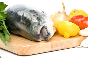 Fresh raw salmon with vegetables on a white background