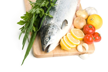 Fresh raw salmon with vegetables on a white background
