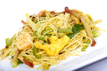 Vegetable and meat asian noodles on a plate with chopsticks