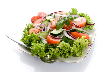 Fresh salad with onion, tomato and basil