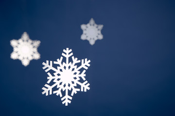 Snowflake Tree Decorations Against Blue Background