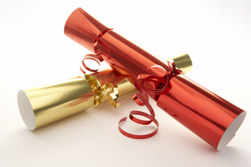 Red And Gold Christmas Crackers Against White Background