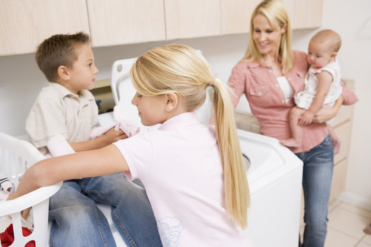 Mother And Children Doing Laundry