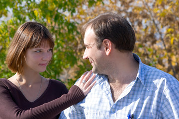 Fototapeta premium The beautiful girl and the young man in autumn park