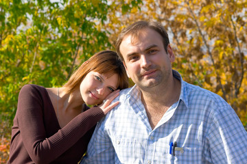 The beautiful girl and the young men in autumn park