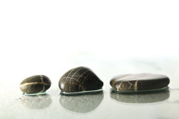 isolated wet zen stones with splashing  water drops