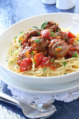 Spaghetti and meatballs, in a tomato sauce.