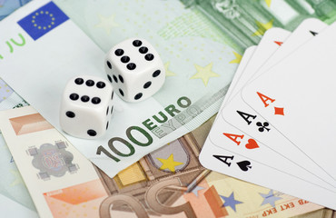 Dices and playing cards over european money