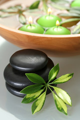 bowl of water with candles and pebbles