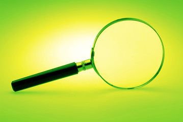 Manual magnifying lens on  green background,  close up