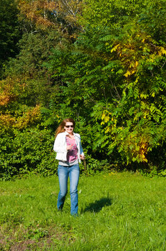 Autumn portrait of a beautiful happy young woman