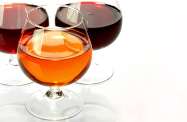 Dark wine in glasses on a glass table