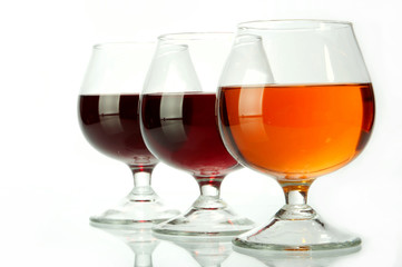 Dark wine in glasses on a glass table