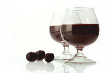 Dark wine in glasses on a glass table