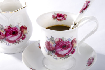 cup of coffee with spoon on white background