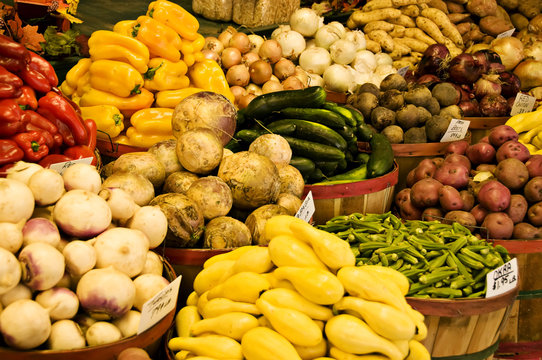 Baskets of Vegetables being displayed at a farmer's market.