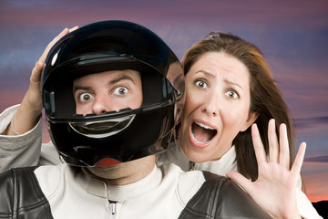 Fototapeta premium Man and fearful woman on a motorcycle in studio