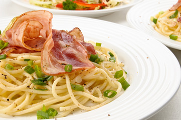 Pasta with fried bacon and vegetables