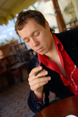 portrait of young man smoking a cigar