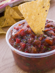 Pot Of Tomato And Coriander Salsa With A Corn Tortilla Chip