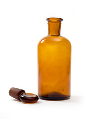 Old amber glass bottle isolated on white.