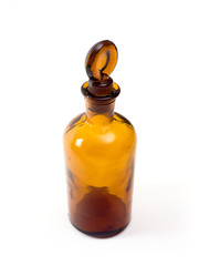 Old amber glass bottle isolated on white.