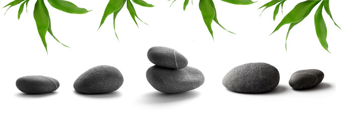 zen-like stones. pebbles and bamboo leaves on white background © KMNPhoto