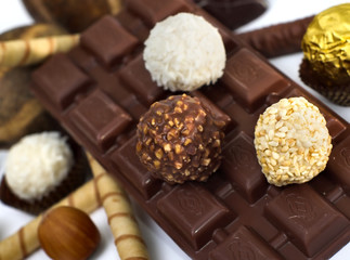 Chocolate and diverse pralines, isolated on white
