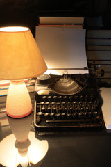 Still-life with antique manual typewriter and lamp
