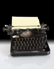 Antique manual typewriter with sheet of paper for your notes
