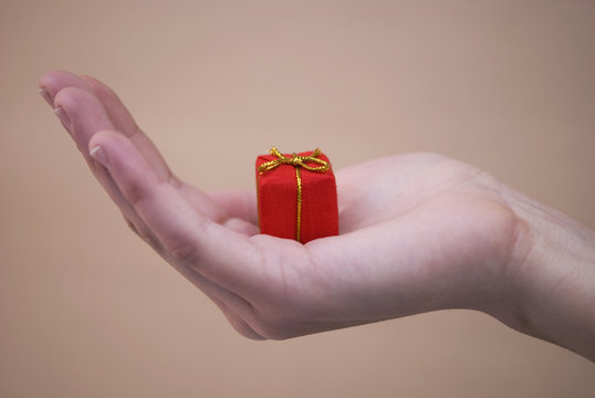 Red gift on woman hand