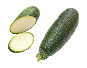 Sliced and whole washed zucchini on white (Cucurbita pepo)