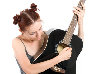 Woman playing acoustic guitar on white background